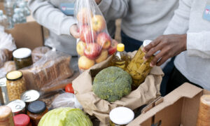 close up of volunteers collecting food donations