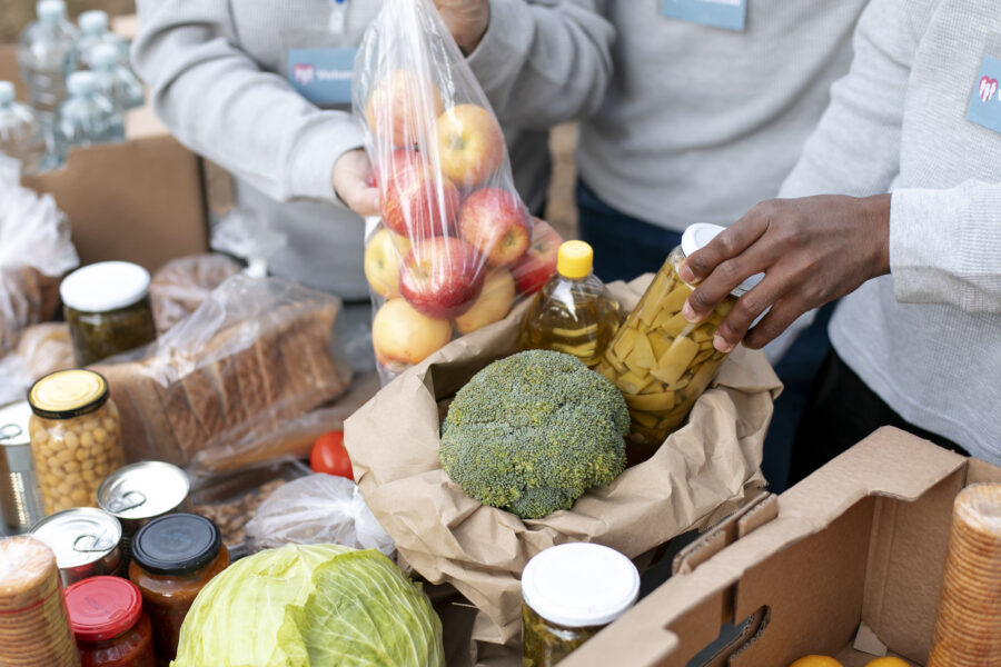 close up of volunteers collecting food donations